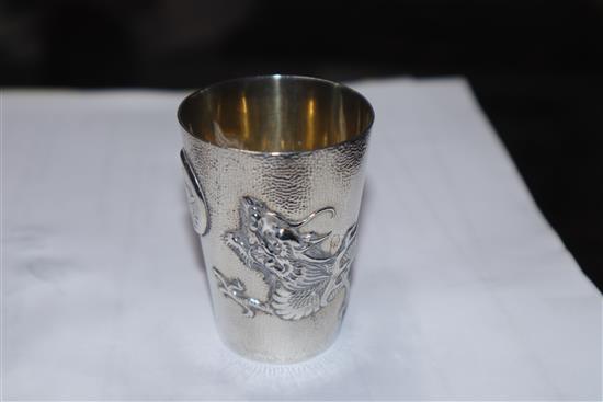 A set of nine early 20th century Chinese Export white metal tots, by Zee Wo, each decorated with a dragon, 13 oz.